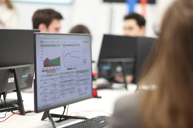 Analyst who knows what is an AI enablement platform and can work with it working on a computer
